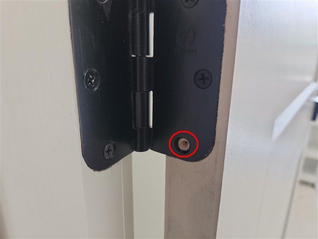 Guest bedroom door missing a hinge screw