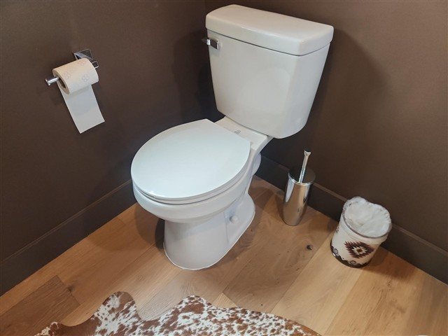 Powder-room toilet loose at the floor