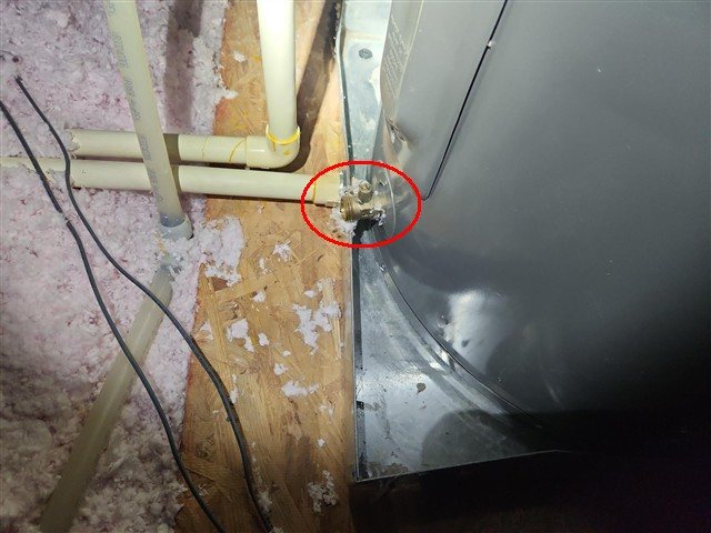 Water-heater drain valve extends over the pan edge